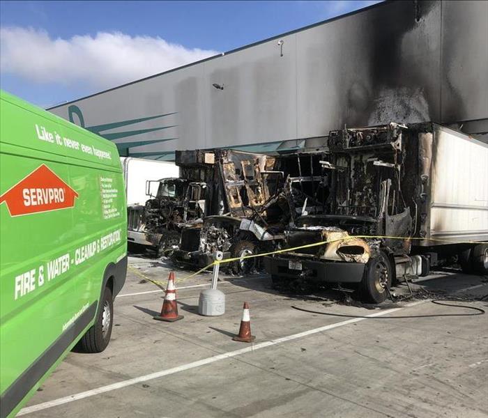 Fire damaged diesel vehicle next to servpro van