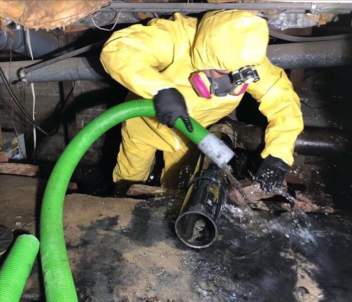 servpro technician in crawl space