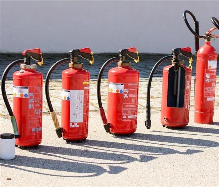 A line up of fire extinguishers